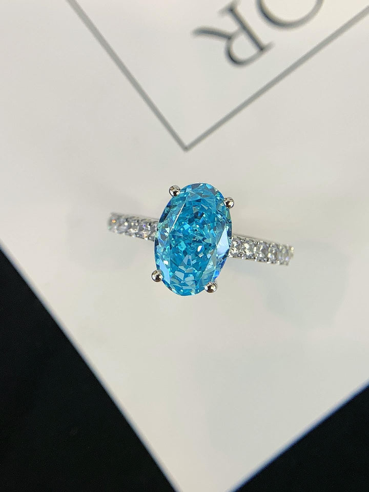 A Promise in Blue — Oval Blue Moissanite Ring · Diamond Band