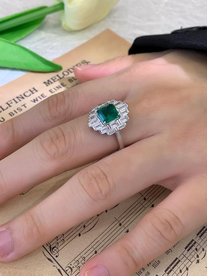 Art Deco, Fully Realized — Emerald Cut Emerald Ring · Baguette Diamond Halo
