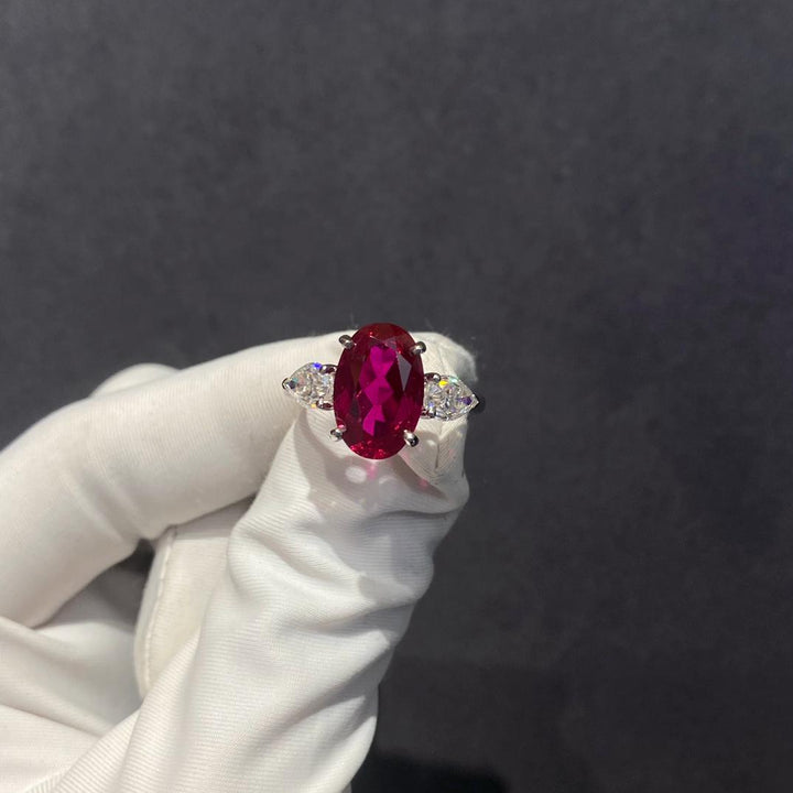 Three Stones, One Fire — Oval Ruby & Pear Diamond Three Stone Ring · White Gold